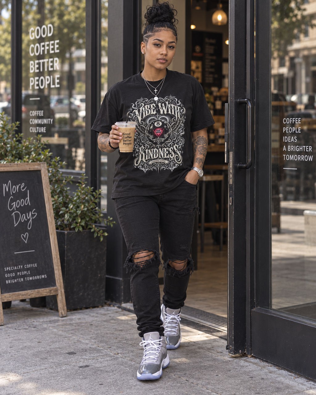 Model wearing the Black ornate 8-ball graphic tee and jeans in a cafe doorway.