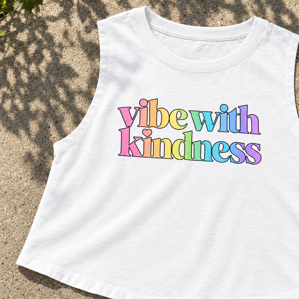 AI-generated styled flatlay close-up of the white Vibe With Kindness rainbow racerback crop top.