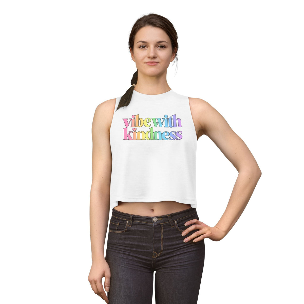 Supplier white model front view of the Vibe With Kindness rainbow racerback crop top.